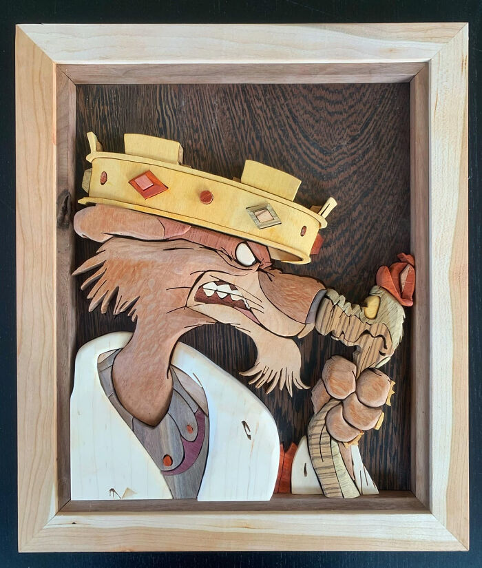 A framed wooden art piece depicting a cartoon character with a crown, a brilliant DIY home project to transform a space.