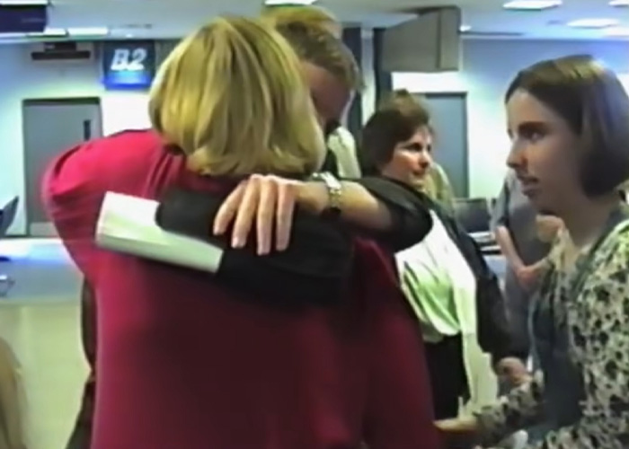 Emotional embrace at an airport, highlighting the relief of escaping a serial criminal.