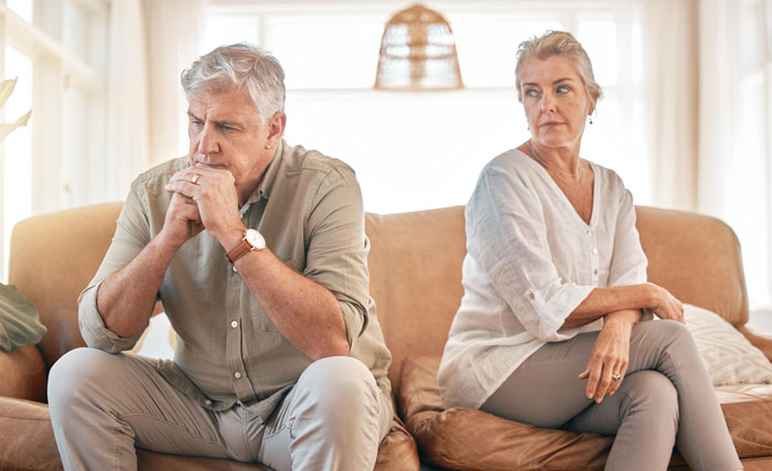 An older couple sits separated on a couch, looking upset, symbolizing the tension created by a SIL who bullies at a wedding. An older couple sits separated on a couch, looking upset, symbolizing the tension created by a SIL who bullies at a wedding.