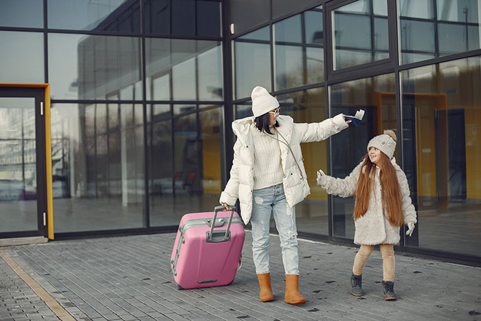 A woman and her adopted baby walk with a pink suitcase outside a modern building, after the sister tries to kidnap her. A woman and her adopted baby walk with a pink suitcase outside a modern building, after the sister tries to kidnap her.