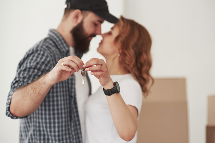 A couple holds house keys, symbolizing the desire for a baby despite infertility taunts.