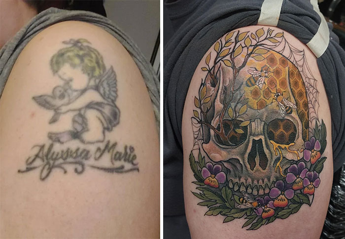 An old cherub tattoo is covered up by an intricate skull with honeycomb and bees, framed by purple flowers.