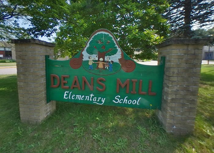 A sign for Dean's Mill Elementary School with a colorful tree and children design. A case about a violent kidnapping. A sign for Dean's Mill Elementary School with a colorful tree and children design. A case about a violent kidnapping.