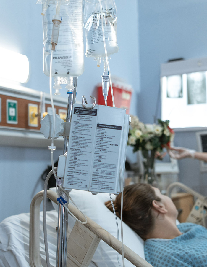 A woman in a hospital bed with an IV, recovering from a violent kidnapping. A woman in a hospital bed with an IV, recovering from a violent kidnapping.