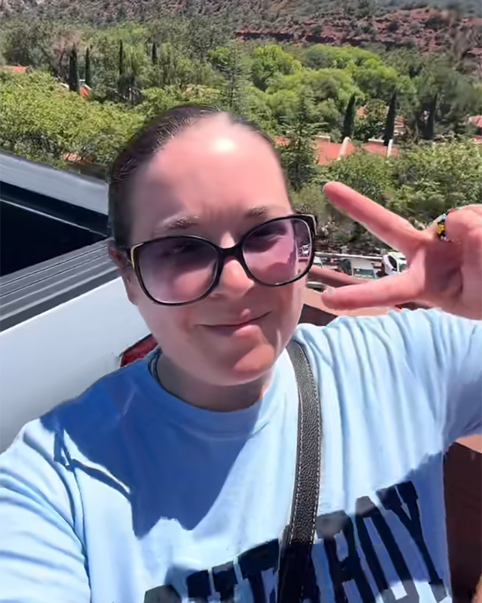 Terminally ill woman smiling, making a peace sign, finding an unexpected way to turn the tables on her husband. Terminally ill woman smiling, making a peace sign, finding an unexpected way to turn the tables on her husband.