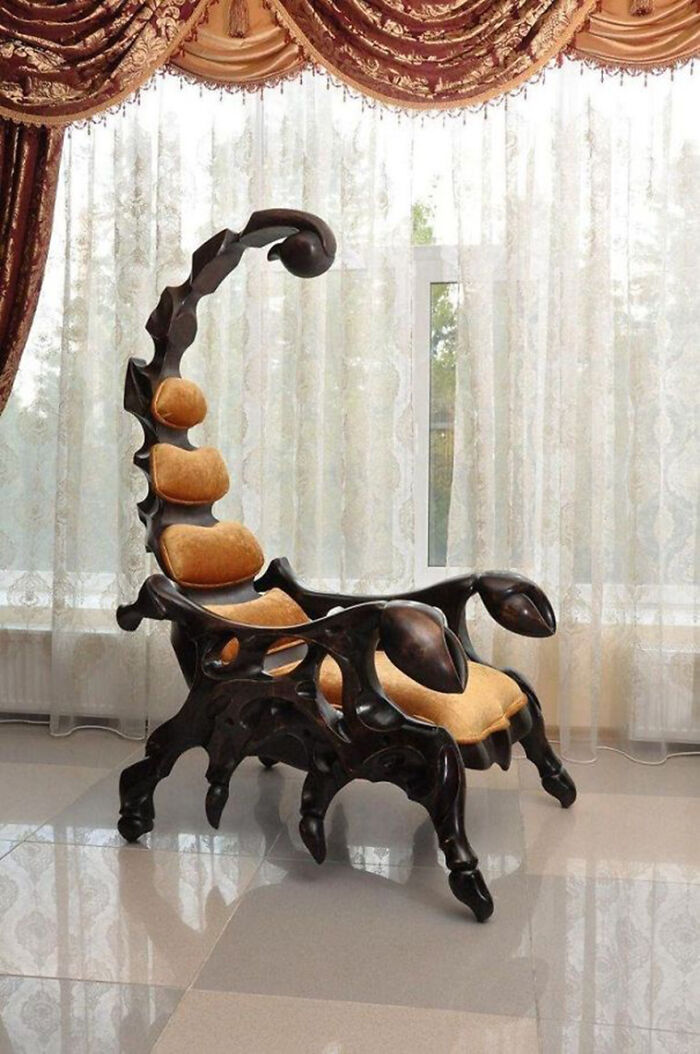 A wooden chair sculpted into the shape of a scorpion, an awful idea with disturbing levels of skill.