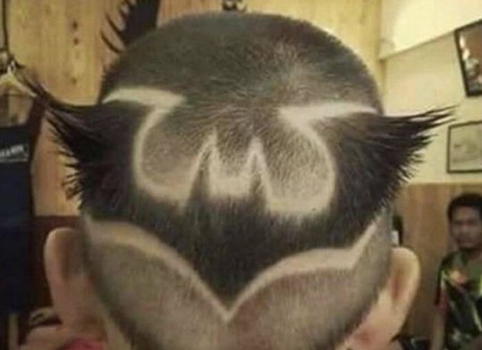 Awful idea: a disturbing Batman logo shaved into the back of a head, executed with skill.