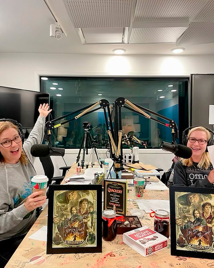 Two women, one an Office star, in a podcast studio with microphones and Lord of the Rings artwork. Two women, one an Office star, in a podcast studio with microphones and Lord of the Rings artwork.