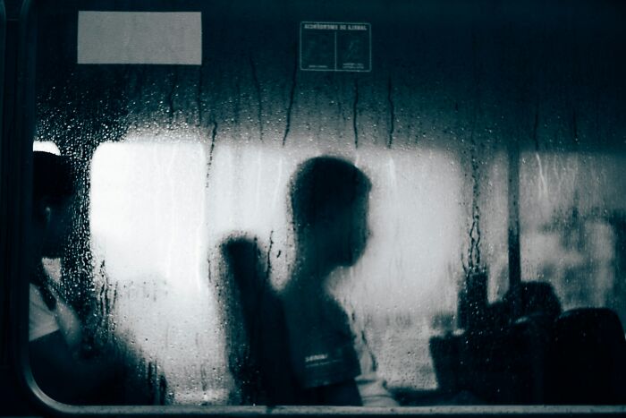 A blurry figure on a bus, symbolizing the isolation of mental health disorders and the difficulty to treat.