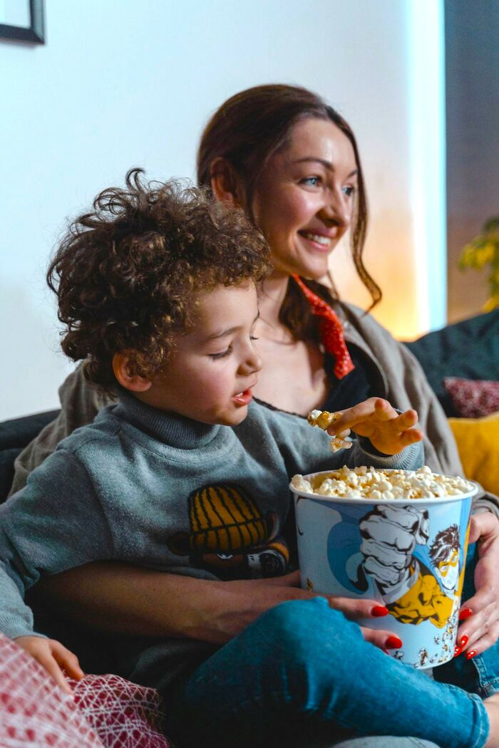 Mother and child enjoying popcorn, illustrating family moments and things America does better.