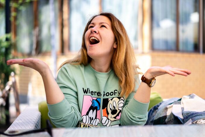 A woman expressing joy and excitement, representing the happiness that America does better.