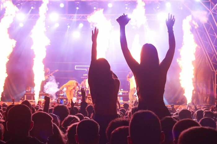 America does better with vibrant live music and entertainment, featuring a crowd enjoying a concert with pyrotechnics.