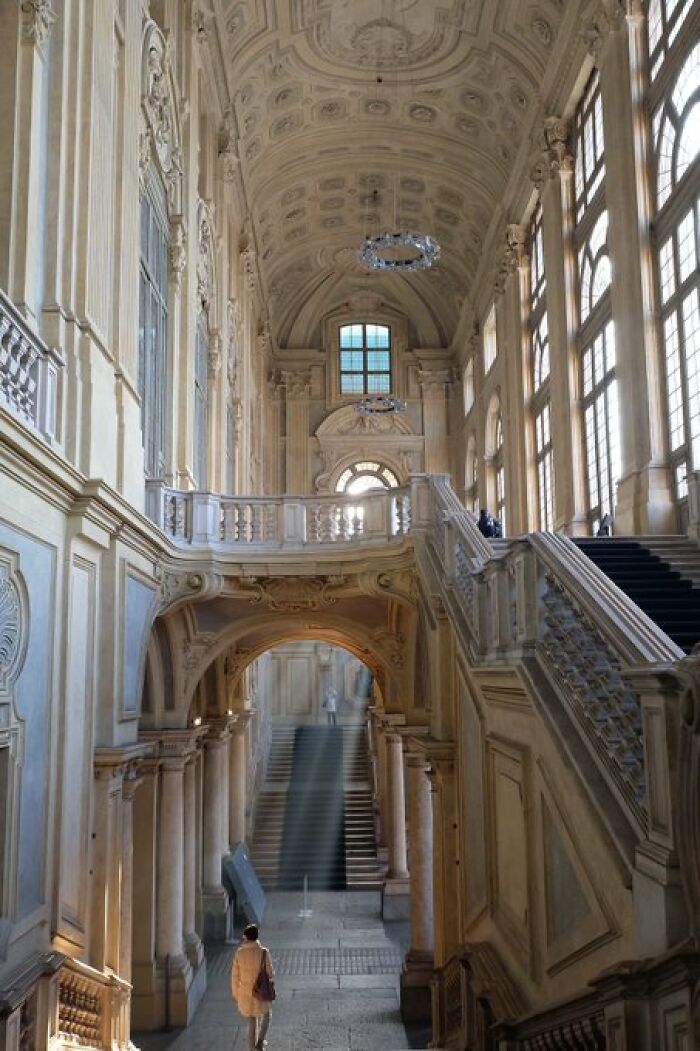 Grand hall with ornate architecture and soaring ceilings, showcasing the character of historical buildings.