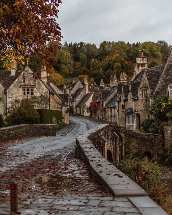 A quaint village street lined with old buildings, each exhibiting distinct character and traditional design.