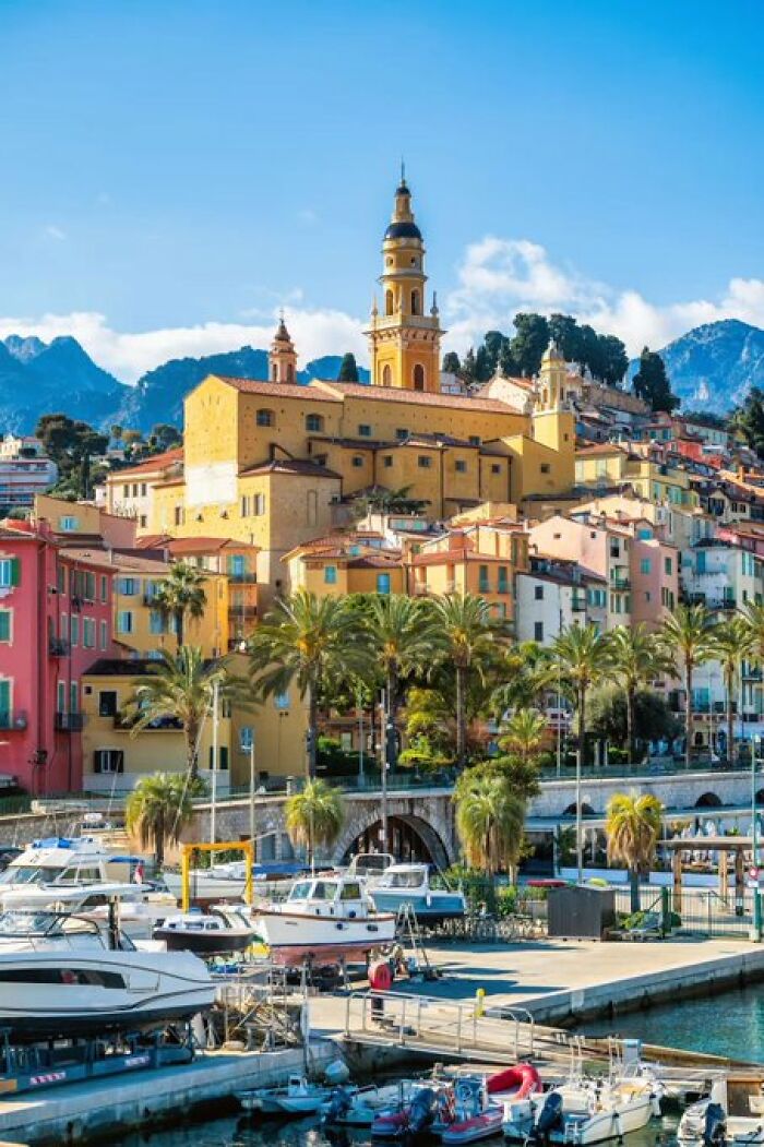 Picturesque harbor town with colorful buildings and a prominent clock tower, displaying buildings with so much character.