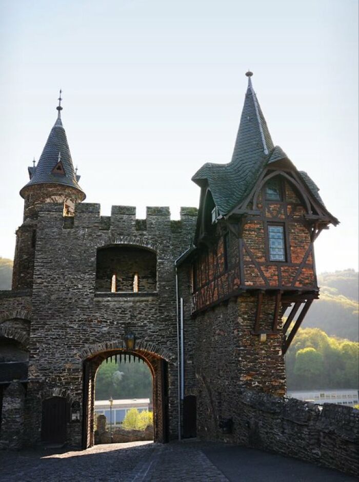 A majestic old castle gate and towers, featuring medieval buildings with character.