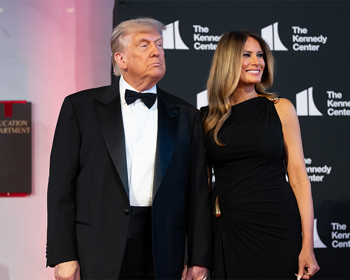 Donald Trump and Melania at an event, both dressed formally, with Melania smiling.