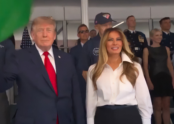 Donald Trump and Melania Trump standing together with Natalie Harp in the background, amid scandal. Donald Trump and Melania Trump standing together with Natalie Harp in the background, amid scandal.