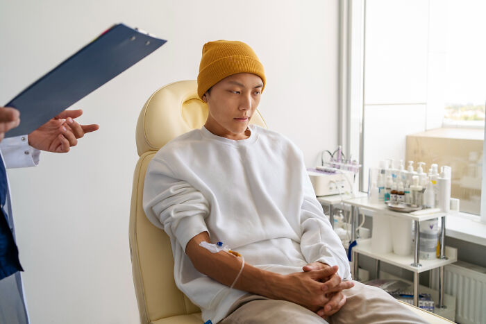 A man in a hospital receiving an IV, representing reasons men signed divorce papers.