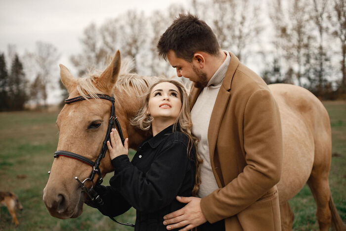 A loving couple with a horse, showing a healthy relationship contrast to divorce struggles.