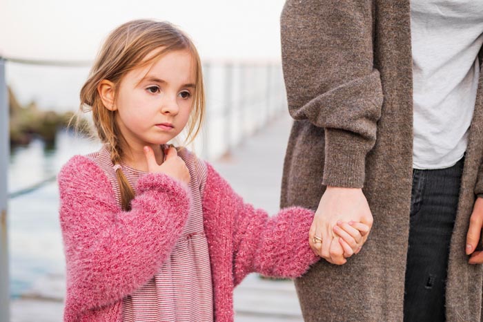 A girl holding her mothers hand, one of the MILs you wouldnt wish upon your worst enemy.