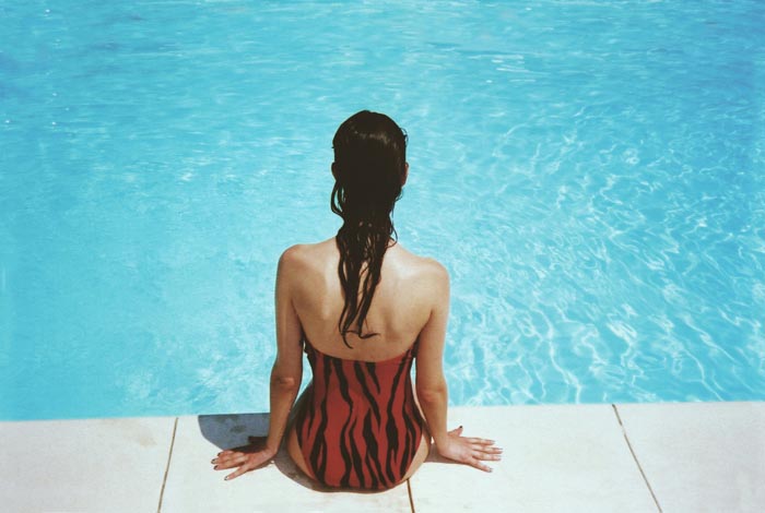 A woman sitting by the pool, one of the MILs you wouldnt wish upon your worst enemy.