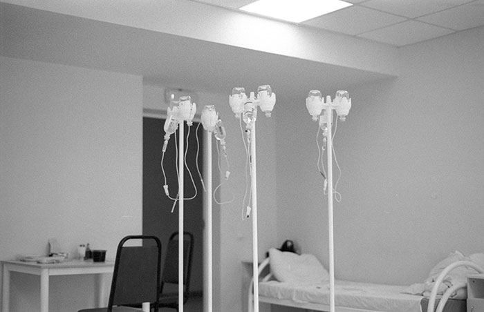 Empty hospital room with IV stands, highlighting the environment where patients might say weird things.