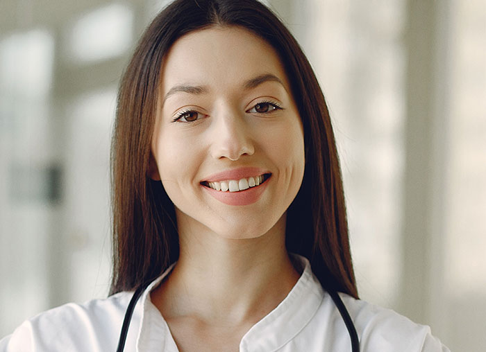 A smiling nurse, representing the healthcare professionals who hear patients say weird things unprovoked.