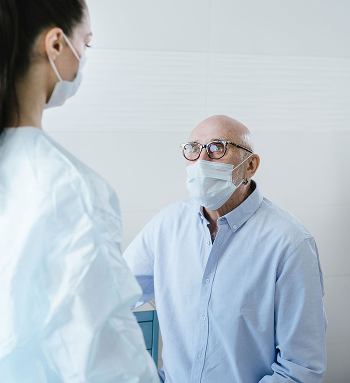 A patient in glasses and a mask talking to a medical professional. Patients said weird things.