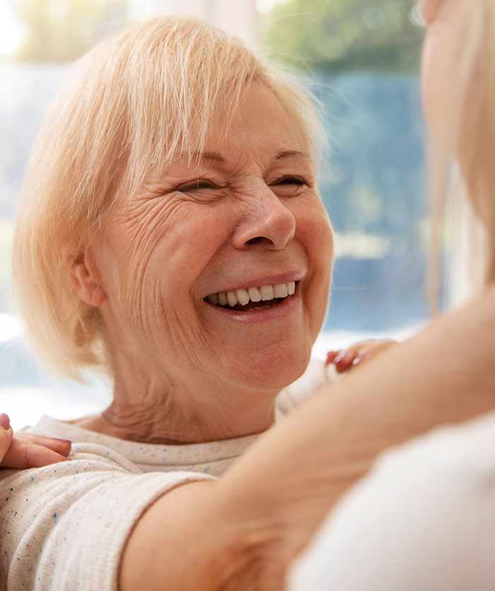 A smiling elderly woman, representing some of the patients who said weird things.