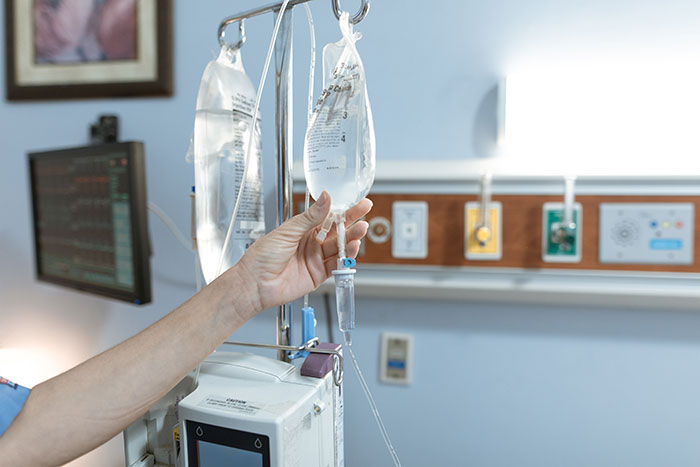 A nurse adjusting an IV drip, highlighting the environment where patients said weird things.
