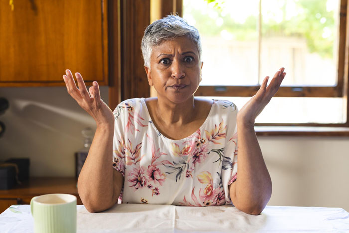 An angry mother-in-law looking frustrated, claiming the bride was gloating about the wedding. An angry mother-in-law looking frustrated, claiming the bride was gloating about the wedding.