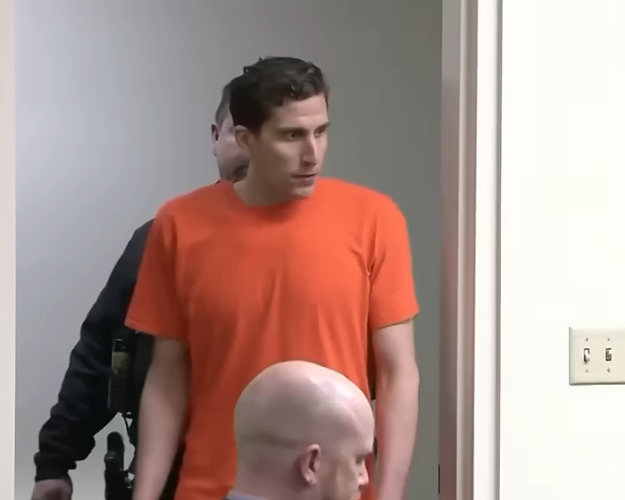 Bryan Kohberger, in an orange jumpsuit, being escorted by officers, related to him targeting a house. Bryan Kohberger, in an orange jumpsuit, being escorted by officers, related to him targeting a house.