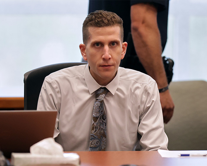 Bryan Kohberger in a courtroom, looking directly at the camera. He is wearing a light-colored shirt and a tie. Bryan Kohberger in a courtroom, looking directly at the camera. He is wearing a light-colored shirt and a tie.