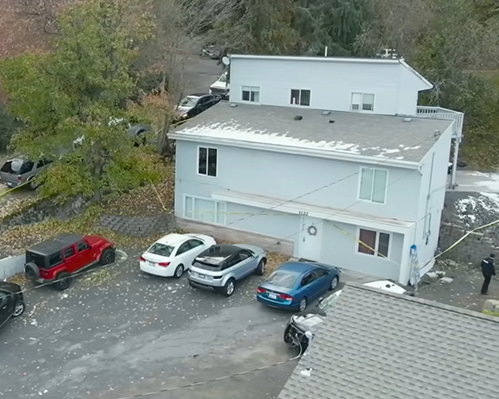 Aerial view of the targeted house in a residential area, surrounded by trees and parked cars. Aerial view of the targeted house in a residential area, surrounded by trees and parked cars.