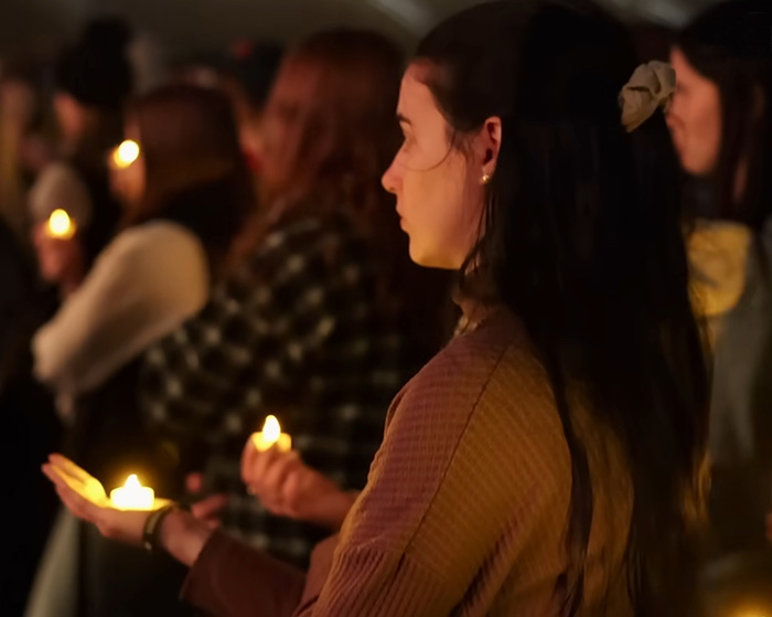 People holding candles at a vigil, remembering the tragedy involving Bryan Kohberger targeting a house. People holding candles at a vigil, remembering the tragedy involving Bryan Kohberger targeting a house.