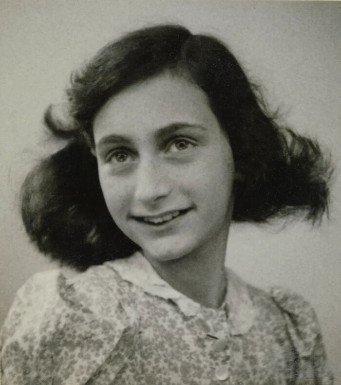 A young Anne Frank smiling, a prominent figure in the historical WWII mysteries that remain unsolved.