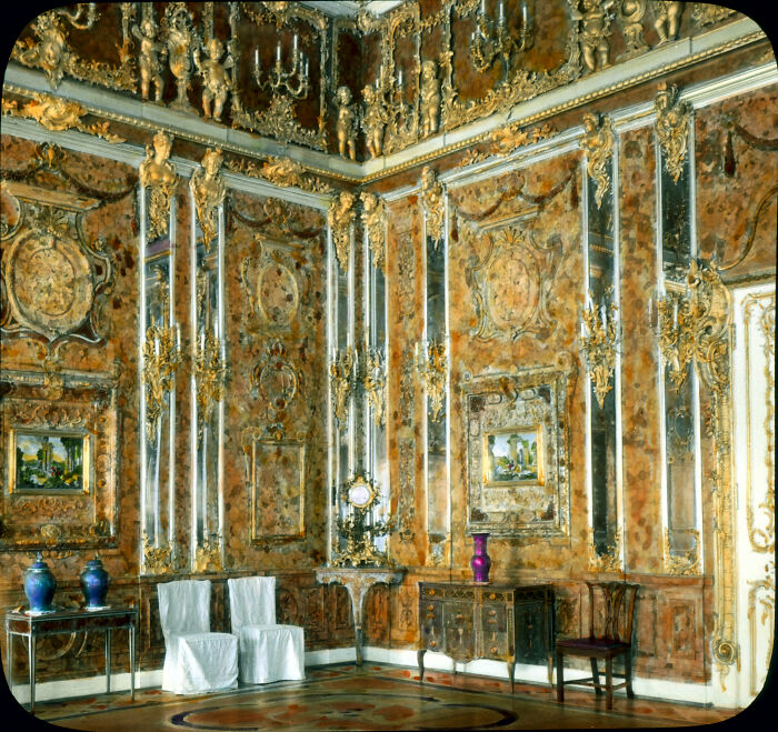 An ornate, opulent amber room with mirrors and gold accents, an intriguing mystery from WWII.