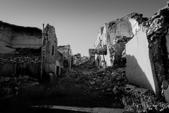 A black and white image of a destroyed town, a powerful visual reflecting WWII mysteries.