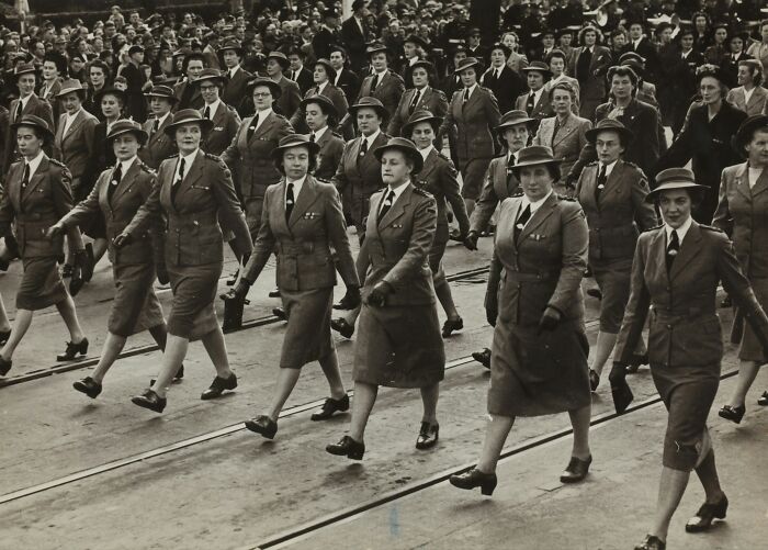 A black and white photo of women in military uniforms marching, representing intriguing mysteries from WWII.