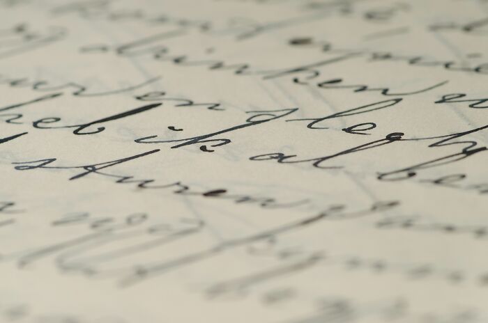A close-up of old handwritten script on faded paper, symbolizing unsolved WWII mysteries.