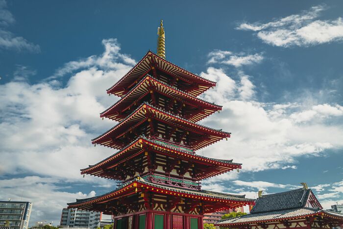 A vibrant, multi-tiered pagoda against a blue sky, reflecting some intriguing WWII mysteries.