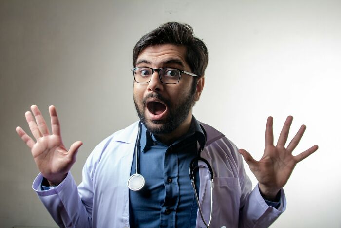 A surprised medical field worker in a lab coat and stethoscope, expressing a common reaction.