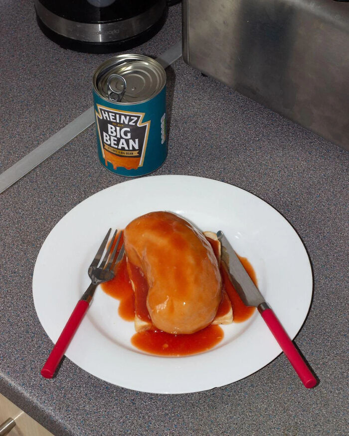 A giant bean on toast with a can of Heinz Big Bean, a classic example of British humor.