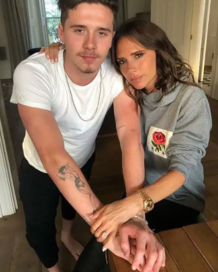 Brooklyn Beckham and Victoria Beckham holding hands. Excruciating wedding, Beckhams family shattered, crime scene morning after. Brooklyn Beckham and Victoria Beckham holding hands. Excruciating wedding, Beckhams family shattered, crime scene morning after.