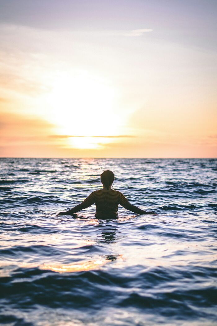 A person in the ocean at sunset, not directly related to wedding moments, but can be seen as an escape from worst wedding moments.