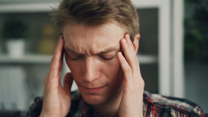 Man with headache, a scary science fact about the human body.