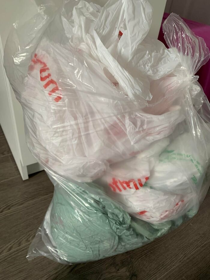 A large bag overflowing with various plastic grocery bags, representing a common poverty habit.