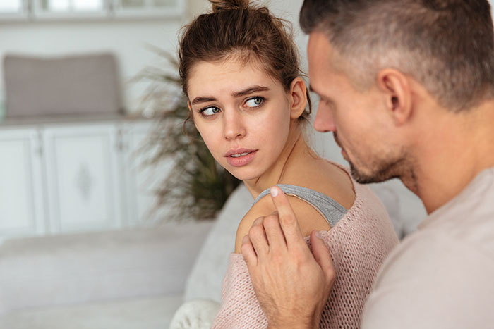 Man finds wife's secret conversations. A man talking to his wife who looks upset while she is turning away from him. Man finds wife's secret conversations. A man talking to his wife who looks upset while she is turning away from him.