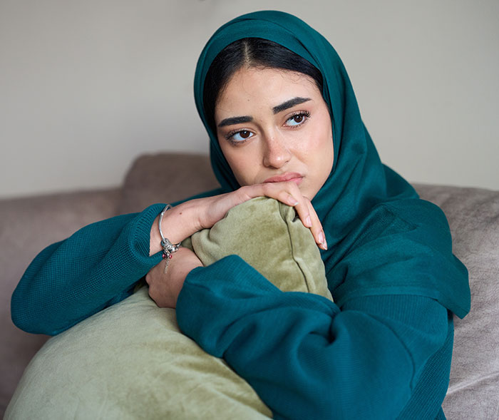 A pregnant woman looking upset after finding her husband's old messages. A pregnant woman looking upset after finding her husband's old messages.